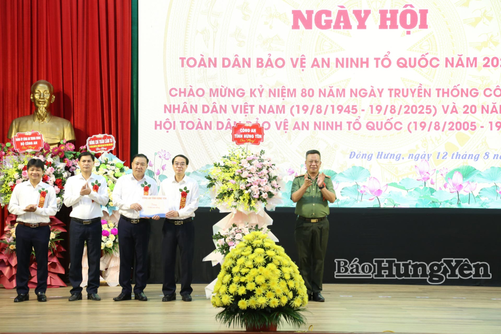 Thiếu tướng Trần Xuân Ánh, Ủy viên Ban Thường vụ Tỉnh ủy, Giám đốc Công an tỉnh tặng hoa và quà chúc mừng ngày hội toàn dân bảo vệ an ninh Tổ quốc tại xã Đông Hưng.