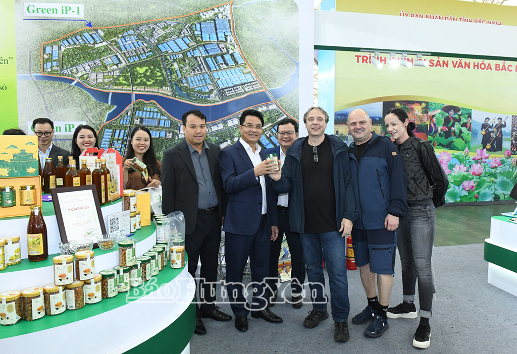 Phó Chủ tịch UBND tỉnh Lê Quang Hòa cùng du khách quốc tế thăm gian hàng trưng bày của tỉnh Hưng Yên tại hội chợ.
